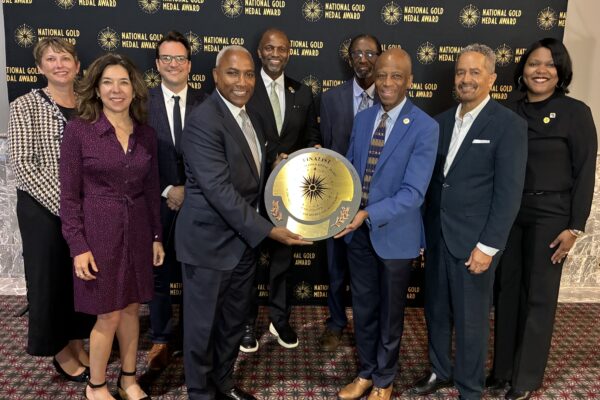 Executive Leadership taking photo at National Recreation and Park Association Conference holding the Gold Medal Finalist plaque.